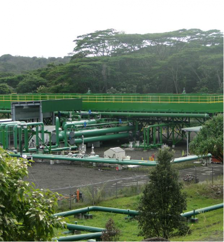 Outside view of geothermal power plant with green pipes in California