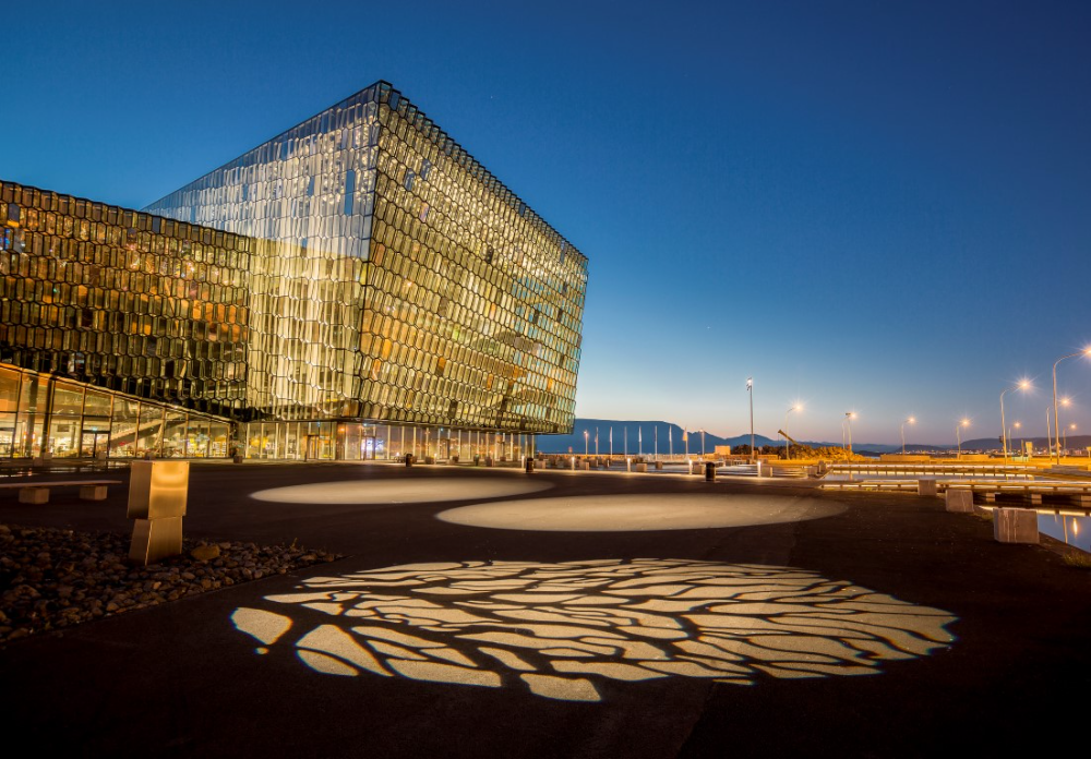 Harpa Conference Center Lit at Night with Shadow on Ground in Front