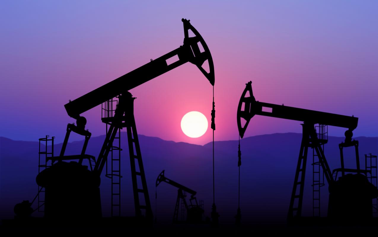 Oil well at sunset (stock photo)