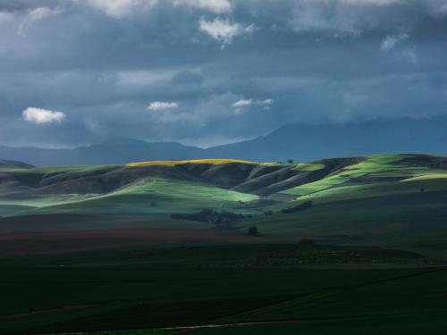 Green foothills against evening sky